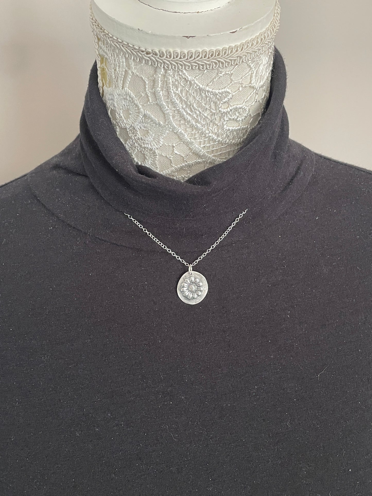 Molly and Me Daisy disc pendant shown on model to give idea of size.