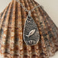 Small silver under the sea necklace on shell