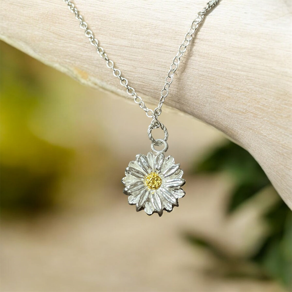 Hanging silver daisy necklace with gold centre 